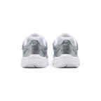 Focuses on the rear profile, highlighting the layered metallic silver heel counter, subtle Nike Swoosh logo, and the wide flared base of the white foam midsole.