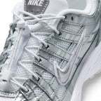 Details the micro-precision of the forefoot, showing the airy white mesh toe box, synthetic leather toe bumper, and the adjustable toggle lock on the laces.