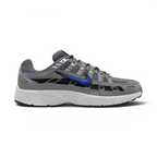 Highlights the lateral profile featuring a bold Racer Blue Nike Swoosh sweeping across the Smoke Grey mesh upper, structured Light Smoke Grey synthetic overlays, dark black underlay panels, and a clean white foam midsole.