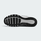 Displays the full-length black and white rubber sole, showcasing the waffle-inspired tread pods and central flex grooves for multi-surface grip.
