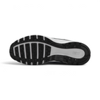Displays the full-length black and white rubber sole, showcasing the waffle-inspired tread pods and central flex grooves for multi-surface grip.