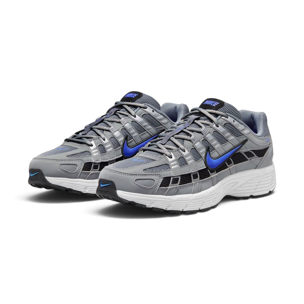 Emphasising the low-cut, athletic 2000s running stance of the trainers and the striking contrast between the neutral grey uppers and electric Racer Blue Swooshes.