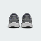 Focuses on the rear profile, highlighting the structured grey synthetic heel counters stamped with Racer Blue micro-Swooshes and blue "P-6000" branding, sitting above the wide white foam midsole base.