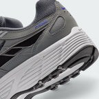 Highlights the "unreal" clean finish where the grooved white foam midsole carrier meets the textured black rubber outsole tread, framing the blue "P-6000" heel overlay badge.