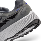 Highlights the "unreal" clean finish where the grooved white foam midsole carrier meets the textured black rubber outsole tread, framing the blue "P-6000" heel overlay badge.