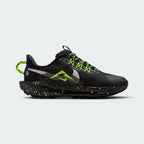 Highlights the high-velocity sweep of the contrasting neon Volt Ice trail logo, showing the professional, multi-textured knit pattern of the black upper, the reinforced sidewall overlays, and the chunky Phantom foam midsole running down to the rugged black lugs.