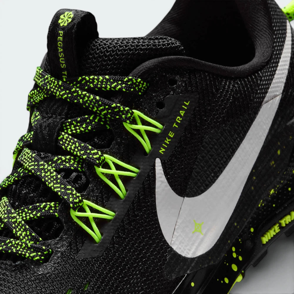 Details the premium precision of the heat-welded synthetic overlays wrapping the front toe box to defend against rock impacts, alongside the clean placement of the miniature Volt Ice Swoosh.