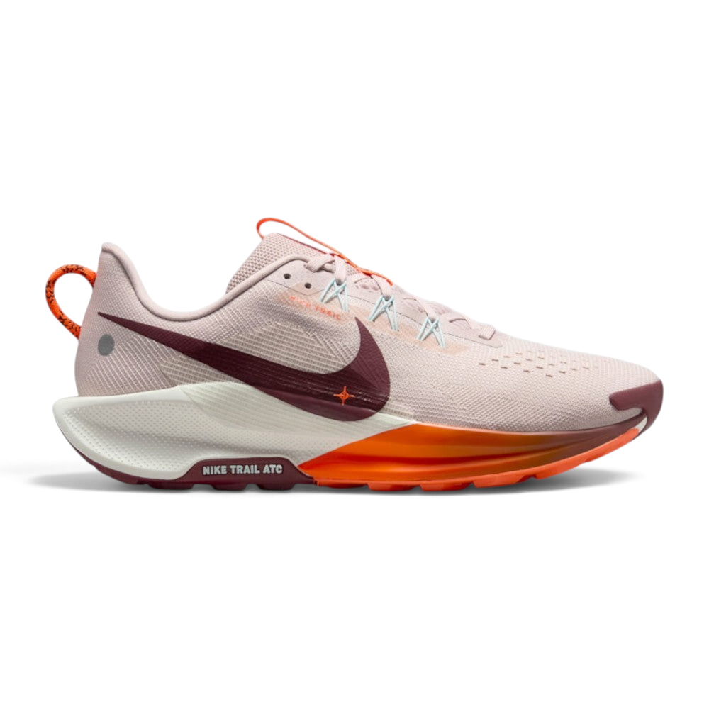 Highlights the lateral profile featuring a Dark Team Red Nike Swoosh sweeping across the Silt Red mesh upper, pale blue Flywire lace loops, Sail ReactX foam midsole with a vibrant Hyper Crimson front midsole section, and the debossed "NIKE TRAIL ATC" outsole badge. Main image