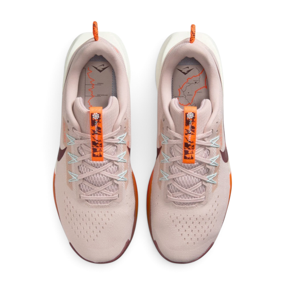 Focuses on the locked-in lacing layout, displaying the Silt Red mesh tongues, matching laces, pale blue Flywire eyelet cables, orange "PEGASUS TRAIL 5" tongue pull ribbons, and custom topographic trail map printed insoles.