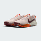 Emphasising the low-cut, aggressive off-road stance of the trainers and the professional color harmony of the Silt Red uppers sitting cleanly above the Sail and Hyper Crimson ReactX foam midsoles.