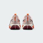 Focuses on the rear profile, highlighting the Hyper Crimson speckled pull loops, circular reflective and orange dots on the heel counters, and the wide footprint of the Sail ReactX midsole base.