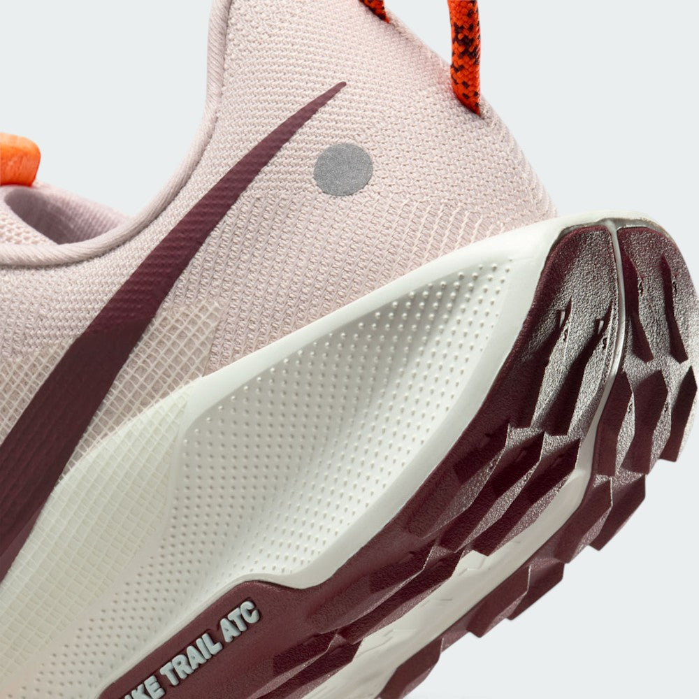Highlights the "unreal" clean finish where the textured Sail ReactX foam midsole meets the Dark Team Red ATC rubber tread, showing the debossed "NIKE TRAIL ATC" outsole frame.