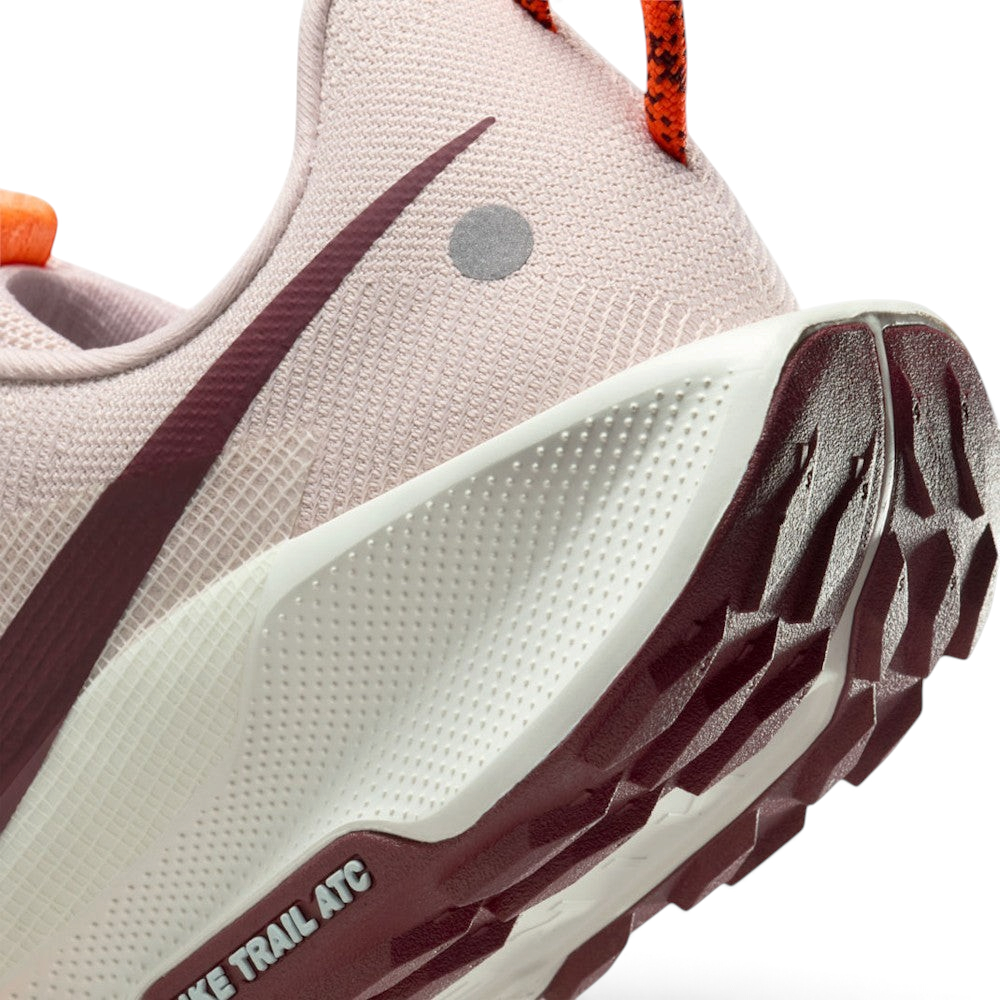 Highlights the "unreal" clean finish where the textured Sail ReactX foam midsole meets the Dark Team Red ATC rubber tread, showing the debossed "NIKE TRAIL ATC" outsole frame.