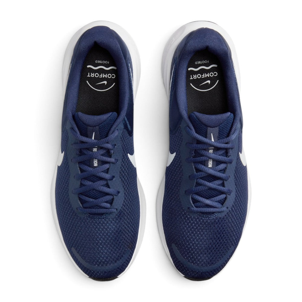 Focuses on the locked-in central lacing layout, displaying the navy laces, mesh tongues with white "NIKE REVOLUTION" branding text, padded navy collars, and black insoles stamped with white "COMFORT FOOTBED" graphics.
