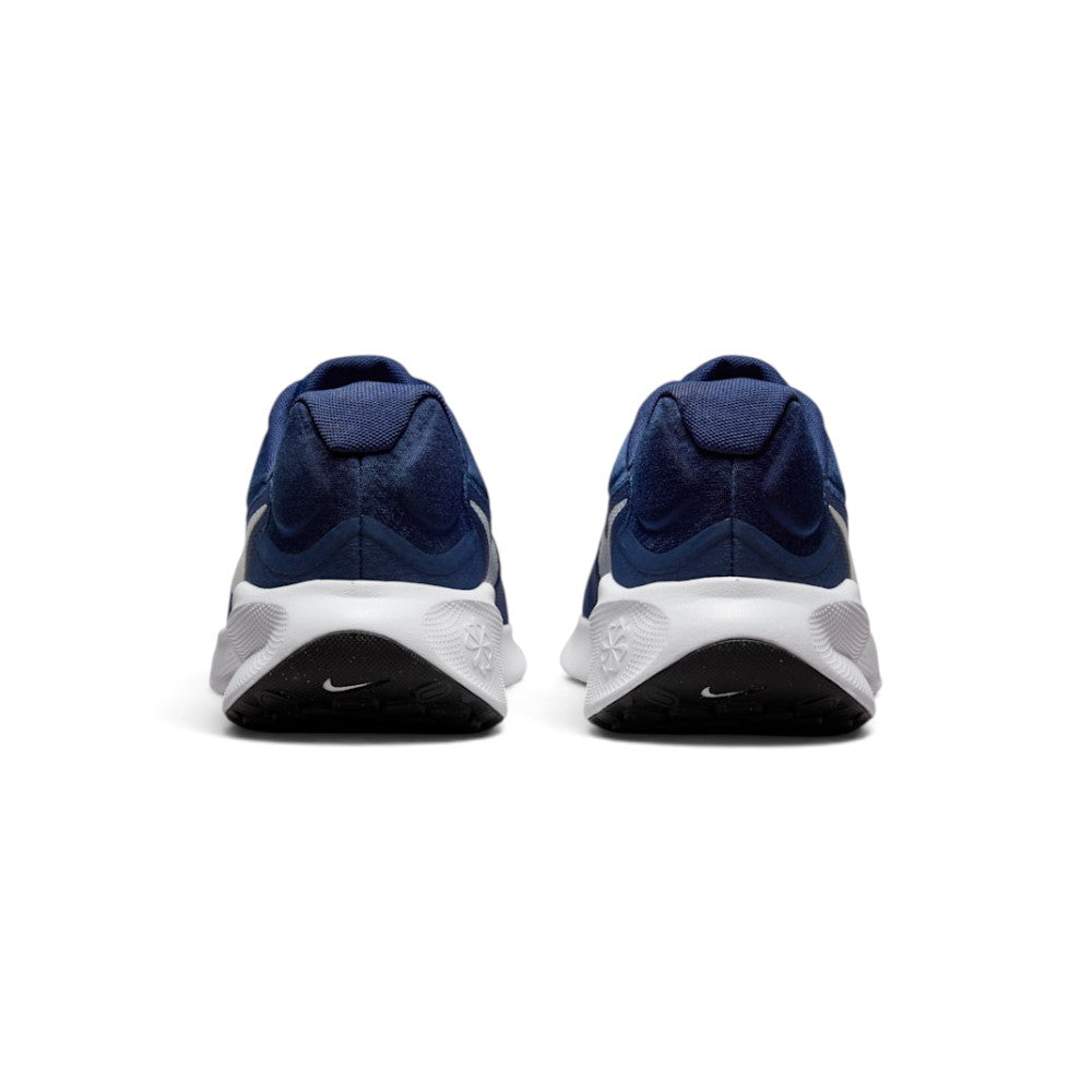 Focuses on the rear profile, highlighting the visible plush Achilles heel puffs, structured navy heel counter, debossed Sunburst emblem on the foam, and black rubber outsole wraps featuring white mini Swooshes.