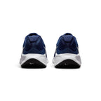 Focuses on the rear profile, highlighting the visible plush Achilles heel puffs, structured navy heel counter, debossed Sunburst emblem on the foam, and black rubber outsole wraps featuring white mini Swooshes.