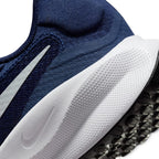 Highlights the "unreal" clean finish where the textured white foam midsole with micro-Swoosh meets the lugged black rubber outsole tread, framing the lower sweep of the white Swoosh and rear heel collar puff.