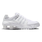 Lateral view showing the streamlined white synthetic leather chassis, tonal micro-perforations, embroidered white mini Swoosh, four independent polyurethane Nike Shox heel columns, sculpted forefoot foam midsole, and white tacky rubber Waffle outsole.