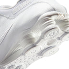 Highlighting the Four Polyurethane Shox Columns, TPU Modulator Plate Texture, Sculpted Forefoot Phylon Foam, and Tacky Waffle Tread Bumper, demonstrating the impact-absorbing depth and track-tested tooling.