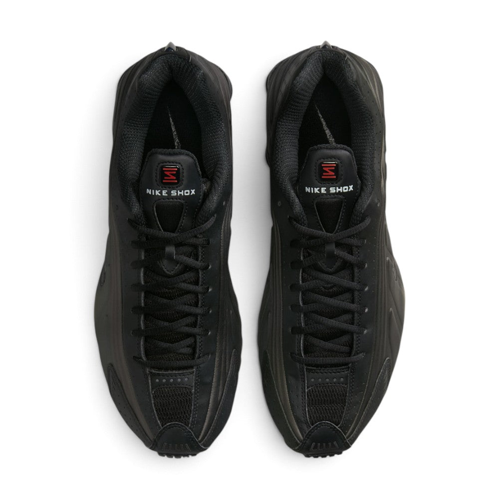 Direct overhead look at both shoes, displaying the streamlined synthetic toe wrap, breathable mesh vamp inserts, central lacing system with flat black laces, padded tongue with Shox emblem, and dark cushioned footbed.