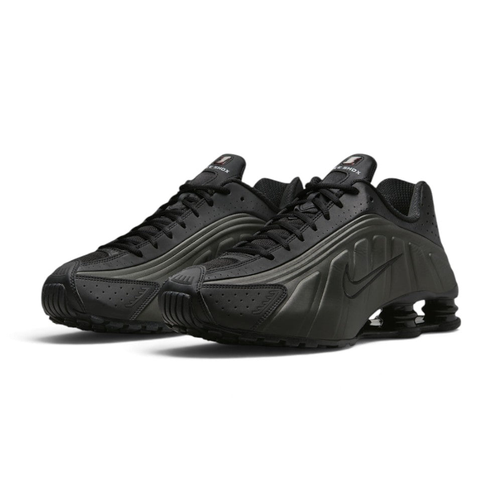 Forward three-quarter angle showcasing both shoes side by side, highlighting the futuristic millennium runner stance, contoured synthetic side ridges, flat black laces, and the striking pop of crimson in the heels.