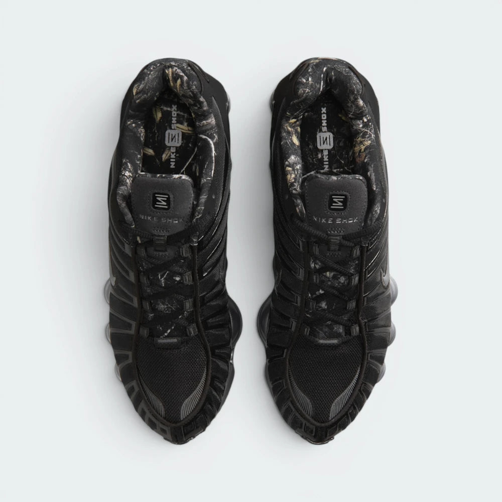 Focuses on the locked-in central lacing layout, displaying the perfect symmetry of the black mesh tongue with "NIKE SHOX" branding, black laces, TPU eyestay overlays, and the RealTree camo print pattern lining the interior collar and footbed.