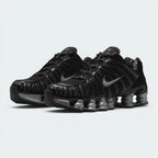 Emphasising the aggressive, forward-leaning mechanical stance of the shoes and the professional contrast between the stealthy black TPU uppers and bright metallic silver Shox pillars.