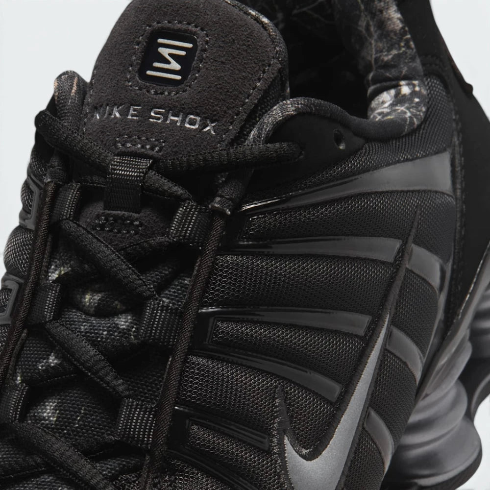 Details the micro-precision of the black mesh toe box, showing the black TPU mudguard cage wrapping the toe tip, rope laces, and suede "NIKE SHOX" tongue badge.