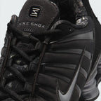 Details the micro-precision of the black mesh toe box, showing the black TPU mudguard cage wrapping the toe tip, rope laces, and suede "NIKE SHOX" tongue badge.
