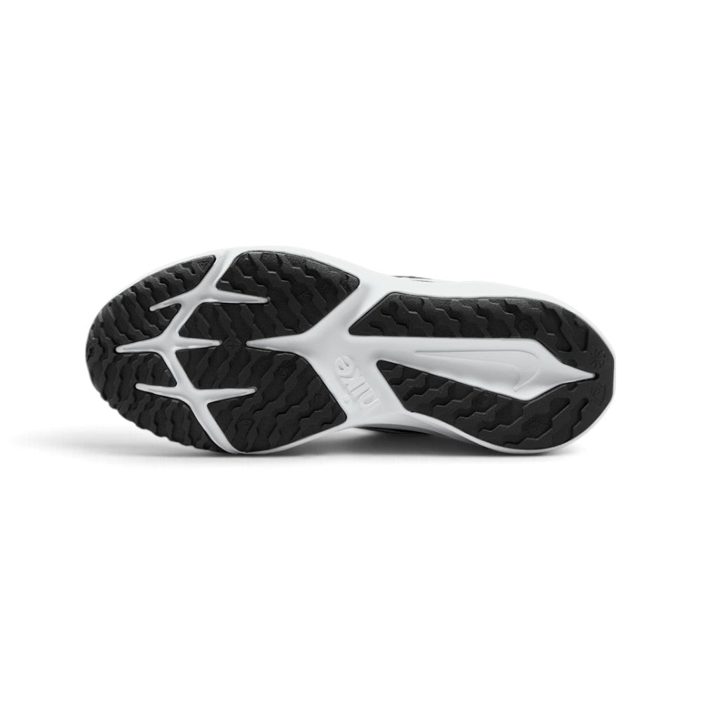 Focusing on the durable multi-surface rubber outsole featuring generative traction grooves and wrapped toe bumper, showcasing the grip matrix engineered for a successful tackle of tarmac, playground grass, and gravel paths.