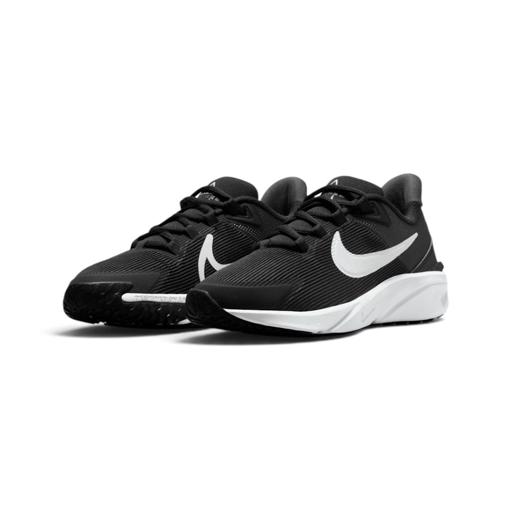 Showcasing the "unreal" clean lines, high-contrast black-and-white colourway pop, and sculpted foam silhouette from a 45-degree perspective.