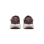 Close-up rear angle focusing on the supportive heel counters, vertical pull tabs for easy entry, curved white-to-purple midsole stack, and the rear ground contact footprint.