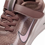 Macro focus on the forefoot and strap closure, detailing the fine mesh weave, secure Velcro hook-and-loop fastening strap stamped with Nike branding, and elastic laces.