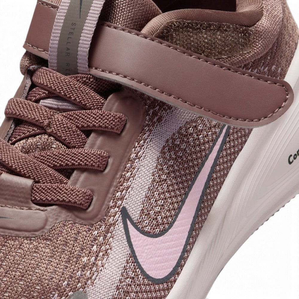 Macro focus on the forefoot and strap closure, detailing the fine mesh weave, secure Velcro hook-and-loop fastening strap stamped with Nike branding, and elastic laces.