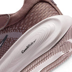 Macro view of the lateral heel transition, highlighting the textured ComfiRide midsole branding stamp and the durable rubber tread wrapping the sole base.