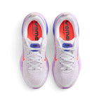 Focuses on the locked-in central lacing layout, displaying the flat white laces, purple-to-blue gradient tongue badges with black "RUN Vomero 18" branding, padded white collars, and bright Hot Lava insoles stamped with bold black "vomero" graphics.