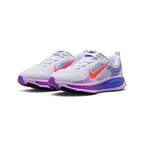 Emphasising the modern, sculpted running stance of the shoes, showcasing the multi-layered purple and blue midsole sidewalls and vivid Hot Lava Swooshes against the clean white mesh.