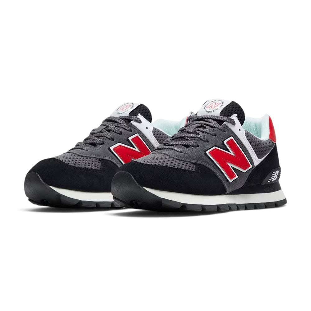 Forward three-quarter angle showcasing both shoes side by side, highlighting the grounded outdoor stance, broad-last shape, rich suede and mesh texture contrast, and vibrant red accents.