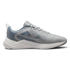 Highlights the lateral profile showing the Light Smoke Grey breathable mesh upper, Metallic Cool Grey Nike Swoosh, integrated midfoot fit band detailing, white foam midsole, and black rubber outsole tread.