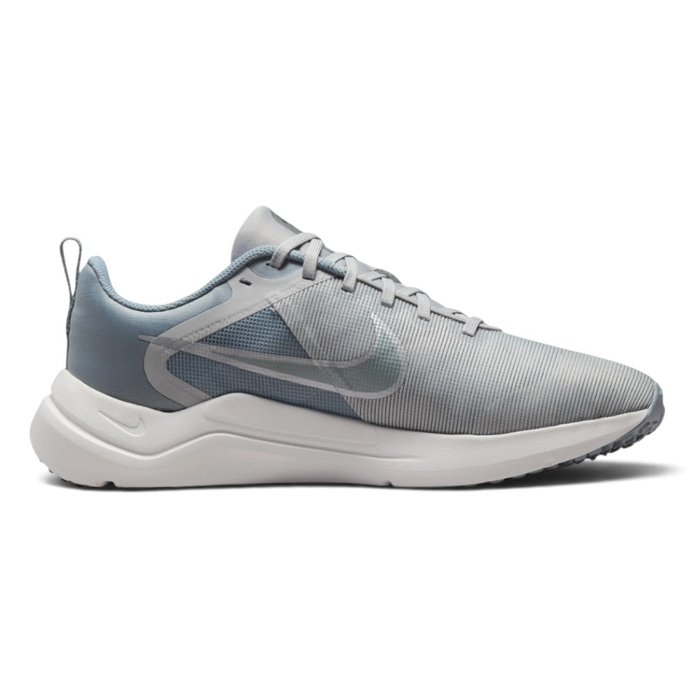 Highlights the lateral profile showing the Light Smoke Grey breathable mesh upper, Metallic Cool Grey Nike Swoosh, integrated midfoot fit band detailing, white foam midsole, and black rubber outsole tread.
