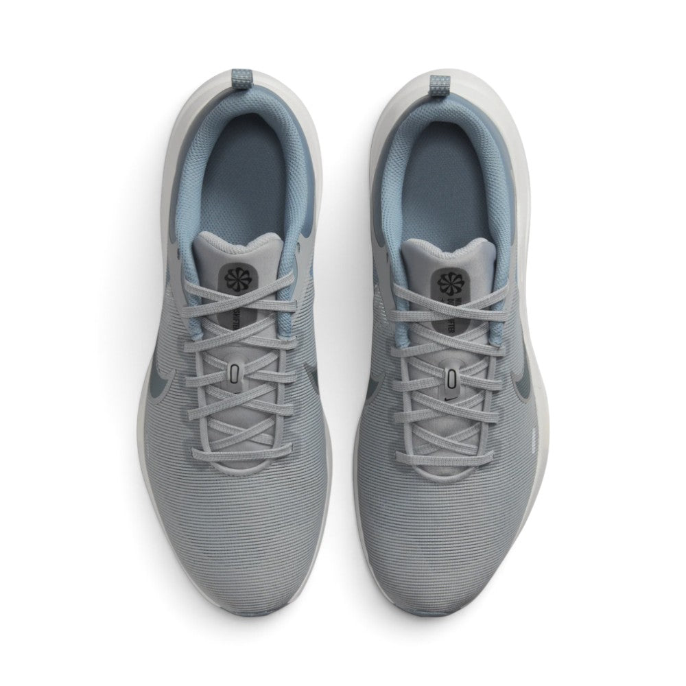 Focuses on the locked-in central lacing layout, displaying Light Smoke Grey laces, mesh tongues with Nike Downshifter branding badges, padded ankle collars, and tonal insoles.