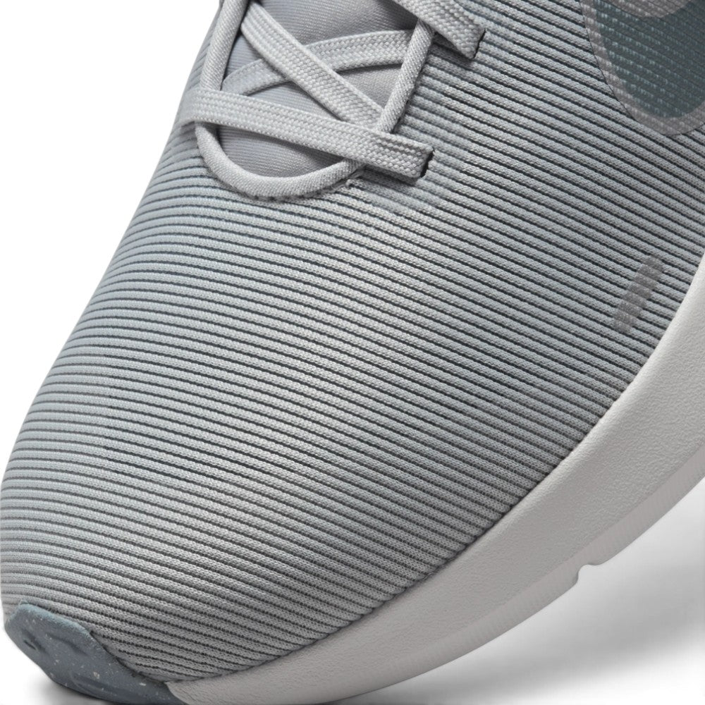 Details the micro-precision of the forefoot mesh upper, showing the reinforced synthetic toe overlay, tonal laces, and integrated midfoot lockdown webbing.