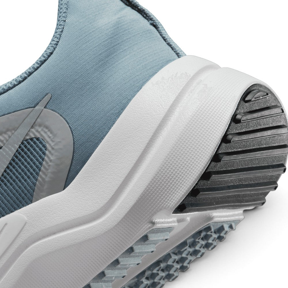 Highlights the "unreal" clean finish where the sculpted white foam midsole meets the grooved black rubber outsole tread.