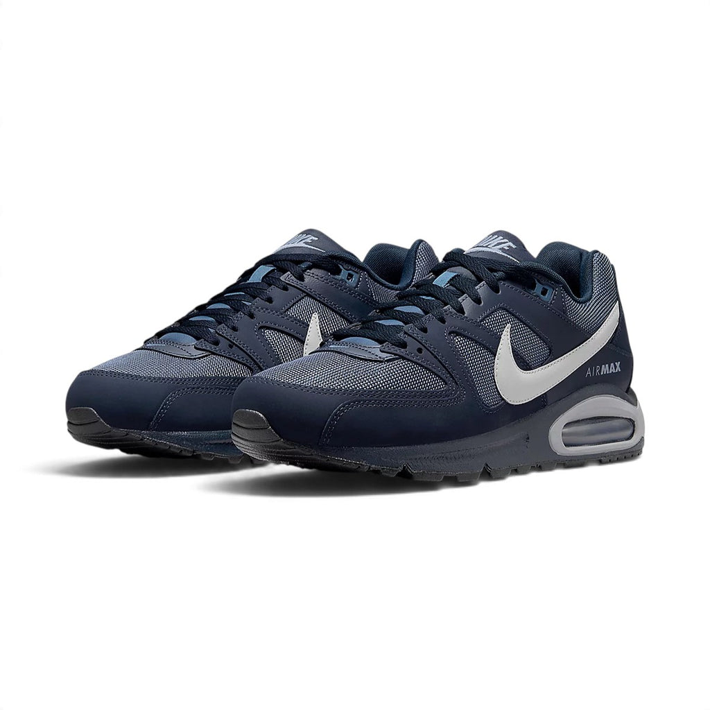 Three-quarter forward angle showcasing both sneakers side by side, highlighting their classic Air Max silhouette and dark navy color blocking.