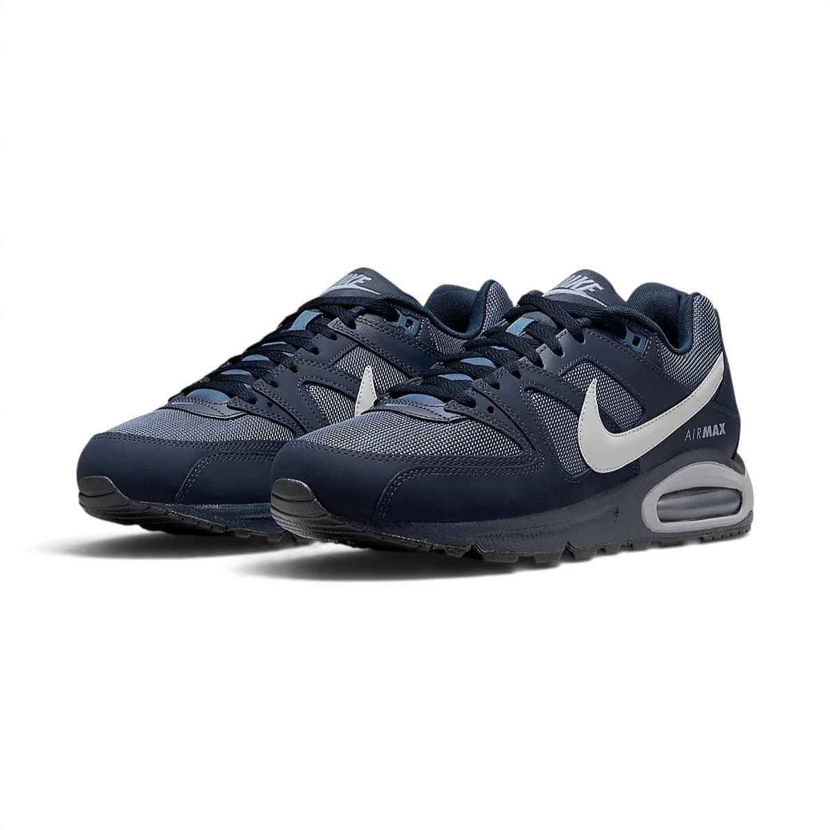 Three-quarter forward angle showcasing both sneakers side by side, highlighting their classic Air Max silhouette and dark navy color blocking.