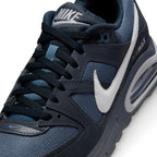 Macro focus on the forefoot and eyestay, detailing the breathable mesh toe box, dark navy laces, tongue branding, and white side Swoosh.