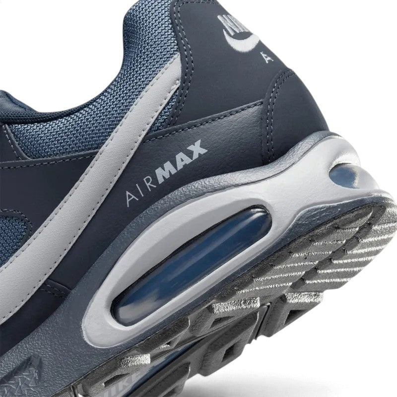 Macro view of the lateral heel transition, highlighting the sculpted midsole, visible Max Air cushioning unit with "AIR MAX" lettering, and the textured Waffle rubber outsole.