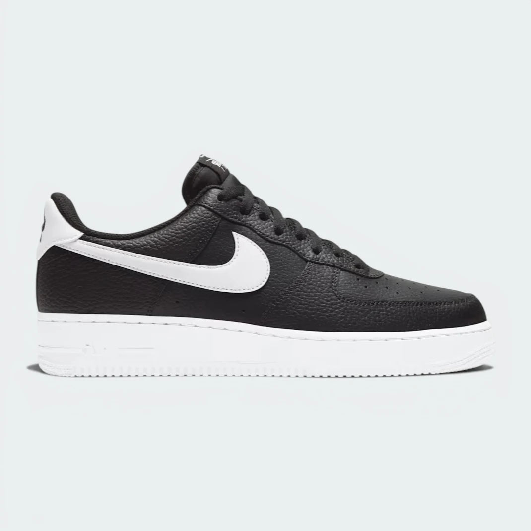 Highlights the iconic silhouette and the high-velocity contrast of the white Swoosh against the black leather.
