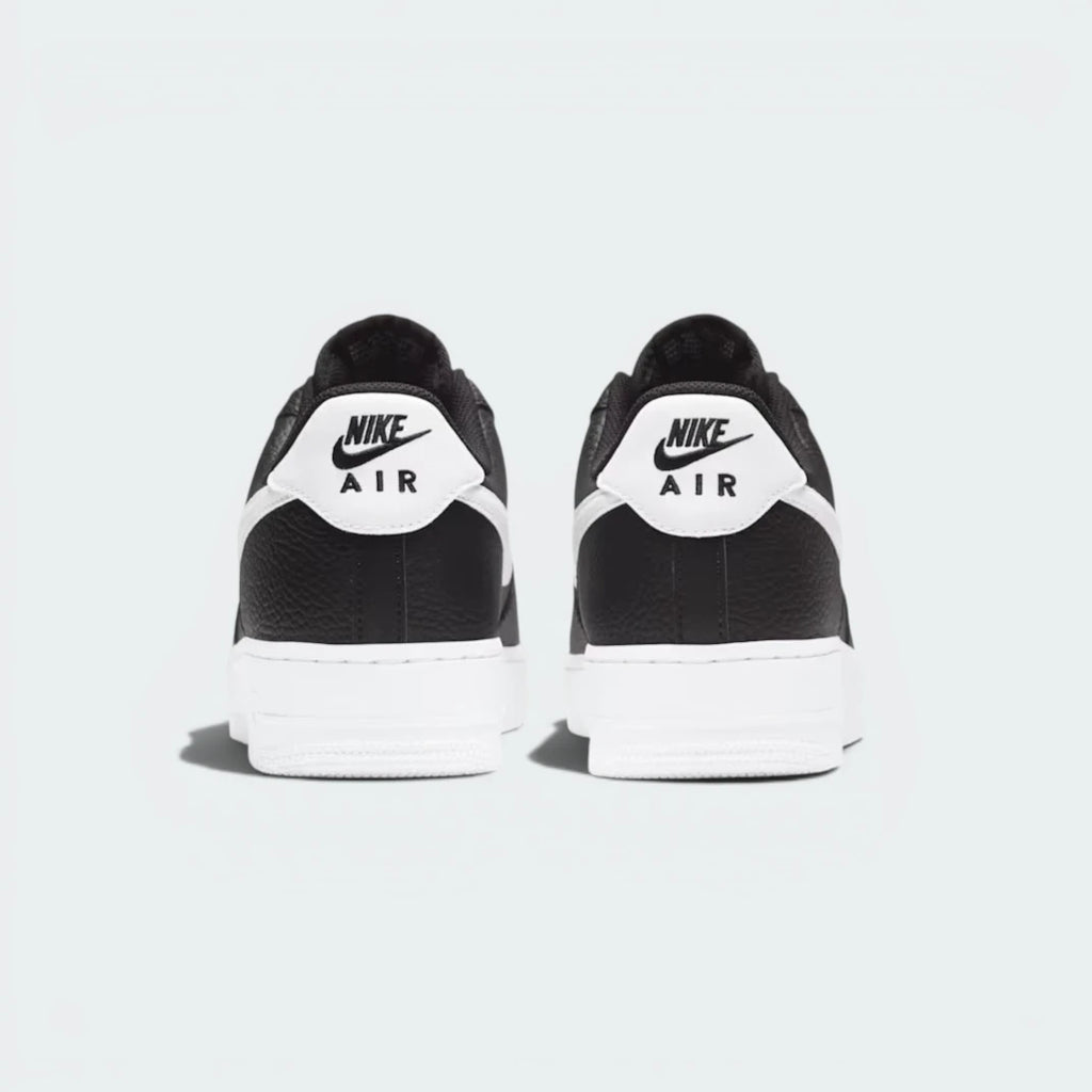 Focuses on the embroidered Nike Air branding and the professional finish of the heel construction.