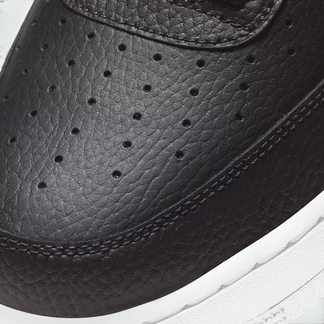 Details the high-definition leather grain and the precision of the AF1 lace dubrae.